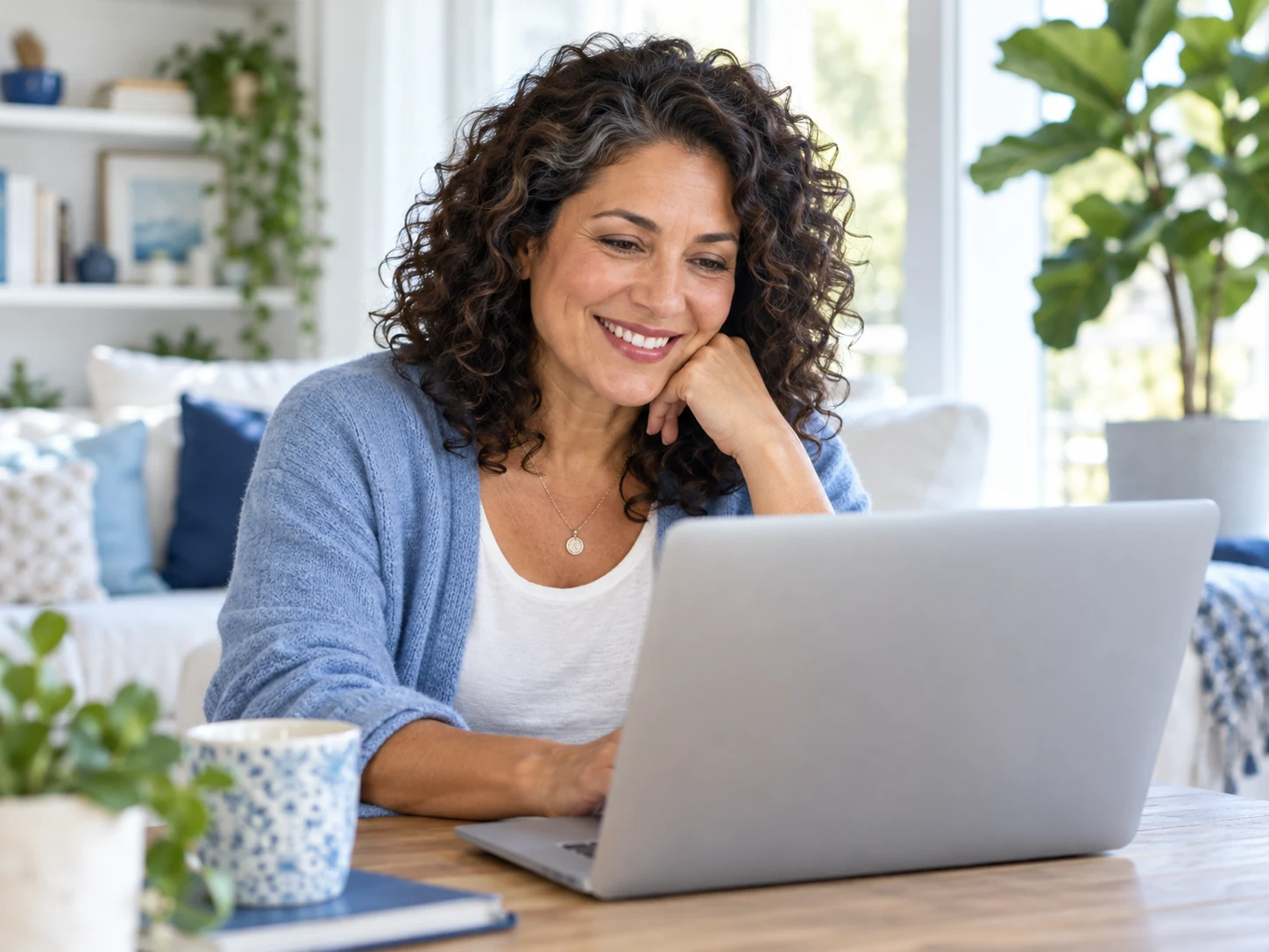 A woman enjoying a relaxed conversation on her laptop at home